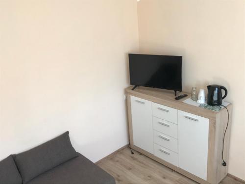 a tv sitting on top of a dresser in a room at Borowiak in Szteklin