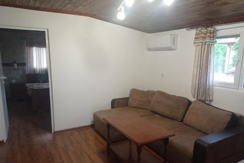 a living room with a couch and a table at Семейна къща Лазарови in Sapareva Banya