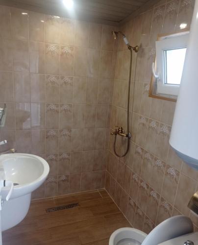 a bathroom with a sink and a shower at Семейна къща Лазарови in Sapareva Banya