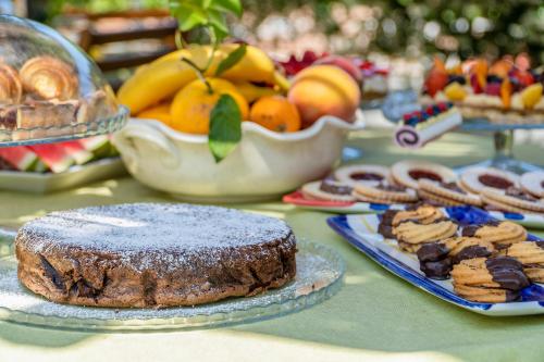 a table with a cake and cookies and other desserts at Villa Iolanda in Piano di Sorrento