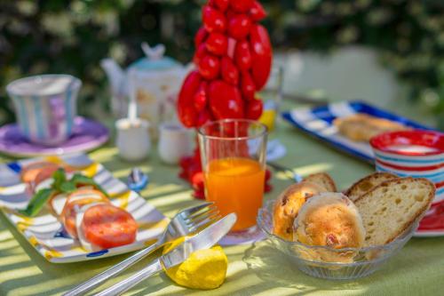 a table topped with plates of food and orange juice at Villa Iolanda in Piano di Sorrento