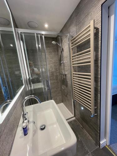 a bathroom with a sink and a shower at The Tavern at Hale in Milnthorpe