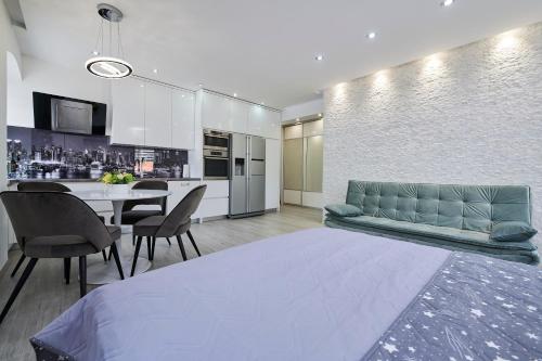a living room and kitchen with a couch and a table at Apartments and Rooms Mišić in Trogir