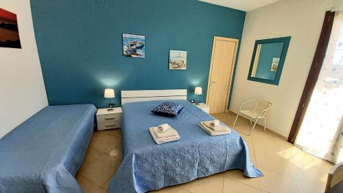 a bedroom with two beds with towels on them at B&B Colori del Salento in Presicce