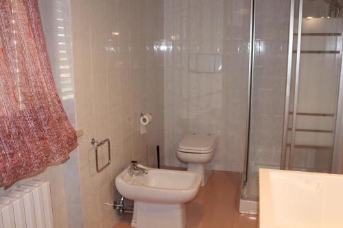 a bathroom with a toilet and a shower and a sink at La casa del Sole in Fermo