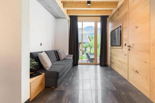 a living room with a couch and a television at Hiša Križaj in Bohinj