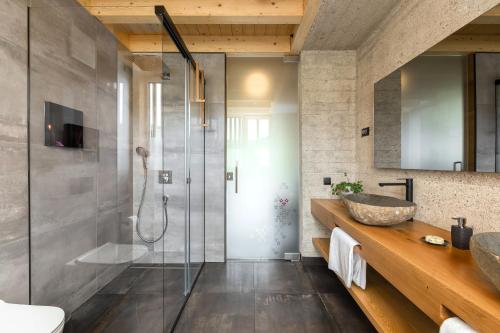 a bathroom with a glass shower and a sink at Hiša Križaj in Bohinj