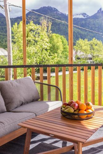 a bowl of fruit on a wooden table on a porch at Hiša Križaj in Bohinj