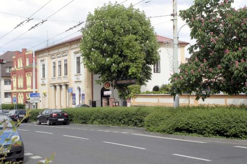 a street with cars parked in front of buildings at Penzion Aladdin in Teplice