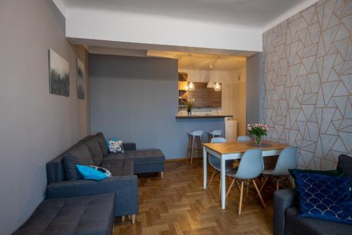 a living room with a couch and a table at Apartament Eliza in Warsaw