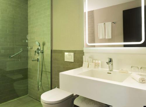 a bathroom with a toilet and a sink and a shower at Park Inn by Radisson Istanbul Atasehir in Istanbul
