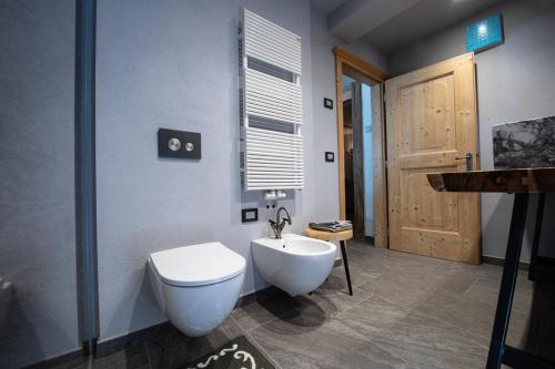 a bathroom with a white toilet and a sink at Chalet degli Abeti by AMA Val di Fassa in Campitello di Fassa
