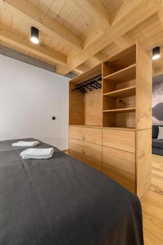 a bedroom with a large bed and wooden cabinets at Hiša Križaj in Bohinj