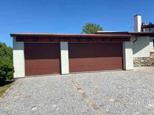 a pair of garage doors on a building at Pension Falko in Český Krumlov