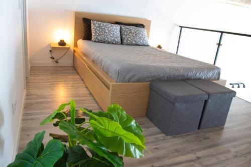 a small bedroom with a bed and plants in it at Loft Porte Sud in Olhão