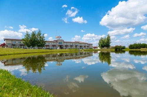 a large body of water in front of a building at Motelis Gariūnai in Vilnius