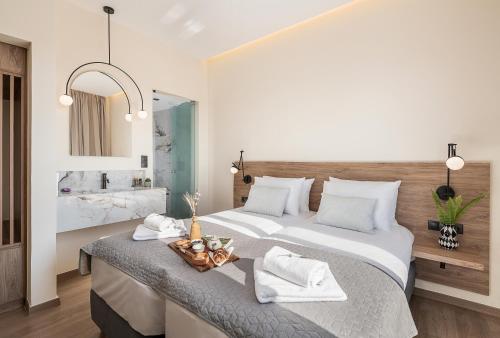 a bedroom with a large bed and a bathroom at Amphitrite Hotel in Chania Town