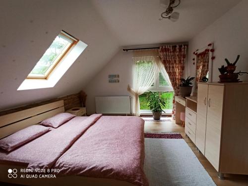 a bedroom with a large bed and a window at Casa Lucia in Dămuc