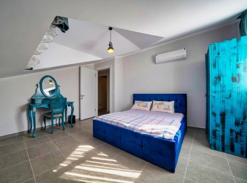 a bedroom with a blue bed and a dressing table at Only Blue Rhapsody in Göcek