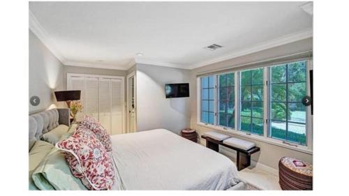 a bedroom with a bed and a large window at Mediterranean Paradise in Fort Lauderdale