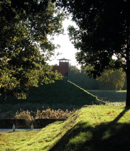 a grassy hill with a tower on top of it at Hotel Vesting Bourtange in Bourtange