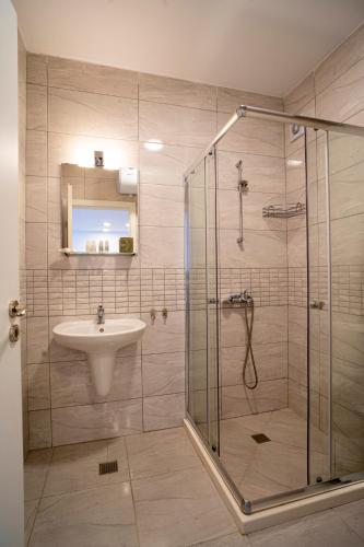 a bathroom with a shower and a sink at Aparthotel Primorsko in Primorsko