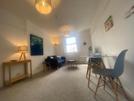 a living room with a couch and a table at Coastal Corner in Mundesley