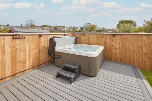 a hot tub sitting on top of a deck at Host & Stay - Badgers Cottage in Brotton