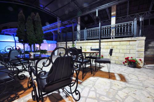 a patio with tables and chairs in a building at Sunny Hill Apartments & Aqua Park in Vrnjačka Banja