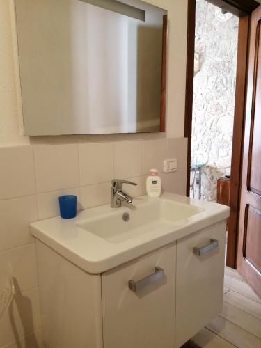 a white sink in a bathroom with a mirror at Per Due in Porto Santo Stefano