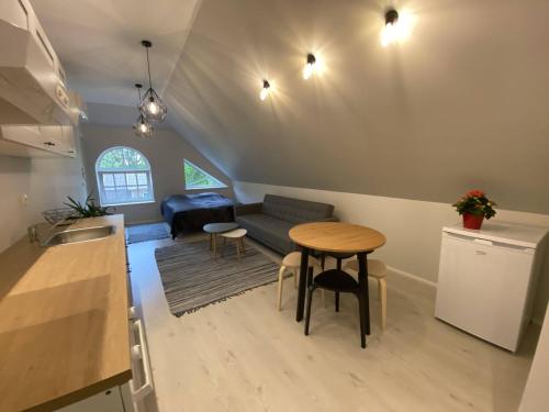 a kitchen and living room with a table and a couch at Captain's House - Kaptenimaja - Apartments in Kärdla