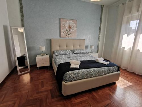 a bedroom with a large bed and a mirror at Casa Ruby in Misterbianco