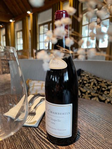 a bottle of wine sitting on top of a table at La Flambée in Sennecey-lès-Dijon