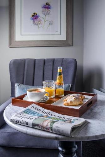 a table with a tray of food and a bottle of beer at Killarney Dromhall Hotel in Killarney