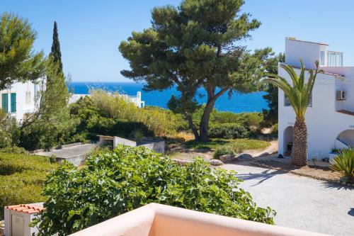 a view of the ocean from the balcony of a house at Apartment Casa Alessandro in Carvoeiro