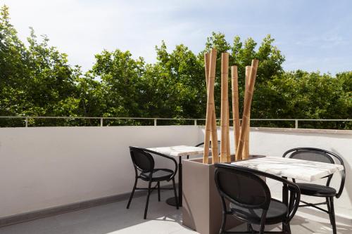 a patio with two tables and chairs on a roof at Nivia Born Boutique Hotel in Palma de Mallorca