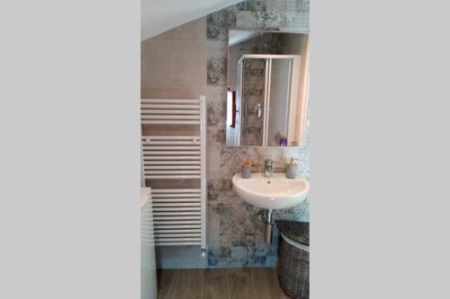a bathroom with a sink and a mirror at Mansarda a Noli in Noli
