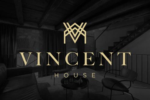 a sign that reads vincent house in a room at Vincent House in Pula