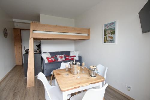 une salle à manger avec une table, des chaises et un canapé dans l'établissement Miellerie du lac, à Gérardmer