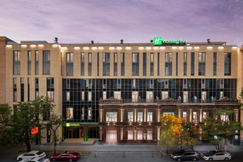 a large building with a hospital sign on top of it at Holiday Inn Yerevan - Republic Square by IHG in Yerevan