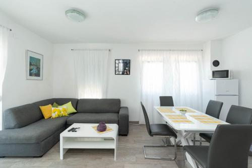 a living room with a couch and a table at Crowonder Luxury Vir- 6 New Apartments for Families with Playground for Kids in Vir