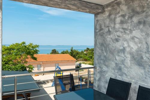 a balcony with a view of the ocean at Crowonder Luxury Vir- 6 New Apartments for Families with Playground for Kids in Vir