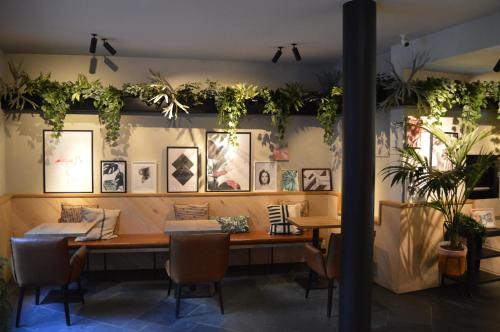 a dining room with a table and plants on the wall at Hotel Indigo Antwerp City Centre by IHG in Antwerp