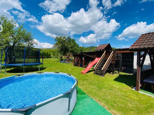 a backyard with a pool and a playground at Apartmany Central Liptov in Liptovský Mikuláš