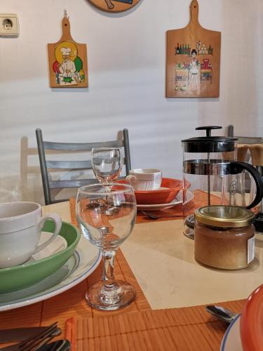 a table with wine glasses and plates on it at Apartman Anđela in Varaždin