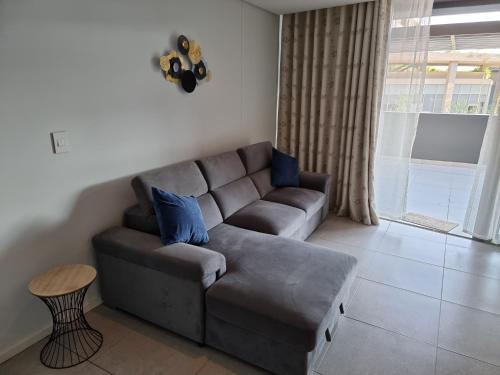 a living room with a couch and a table at OCEANDUNE SIBAYA G023 Block D in Umhlanga