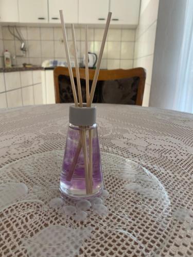 a vase with sticks in it sitting on a table at APARTMAN ADRIANA in Podaca