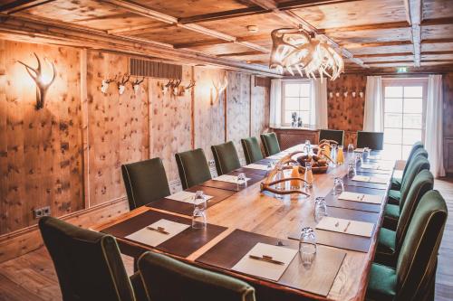 a large conference room with a long table and chairs at Das Achental Resort in Grassau