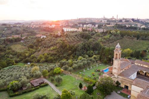 an aerial view of a building with a clock tower at Hotel Certosa Di Maggiano in Siena