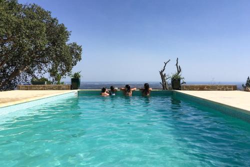 a group of people swimming in a swimming pool at Casa ATMAN in Monchique